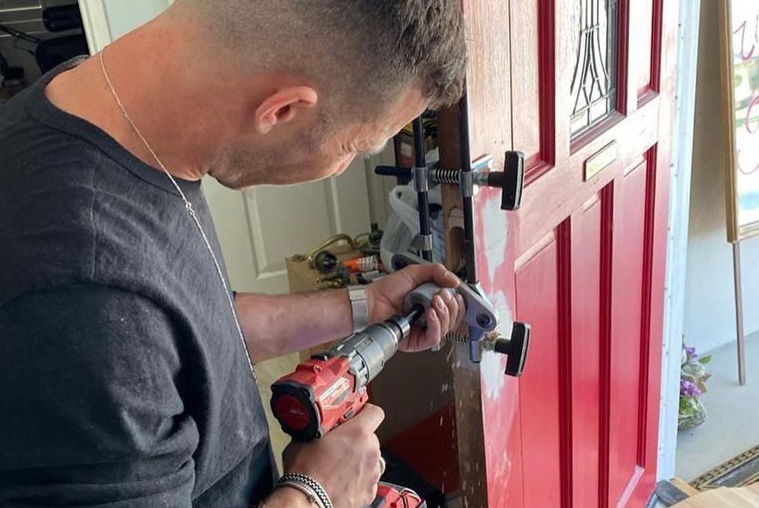 locksmith drilling for a new door lock